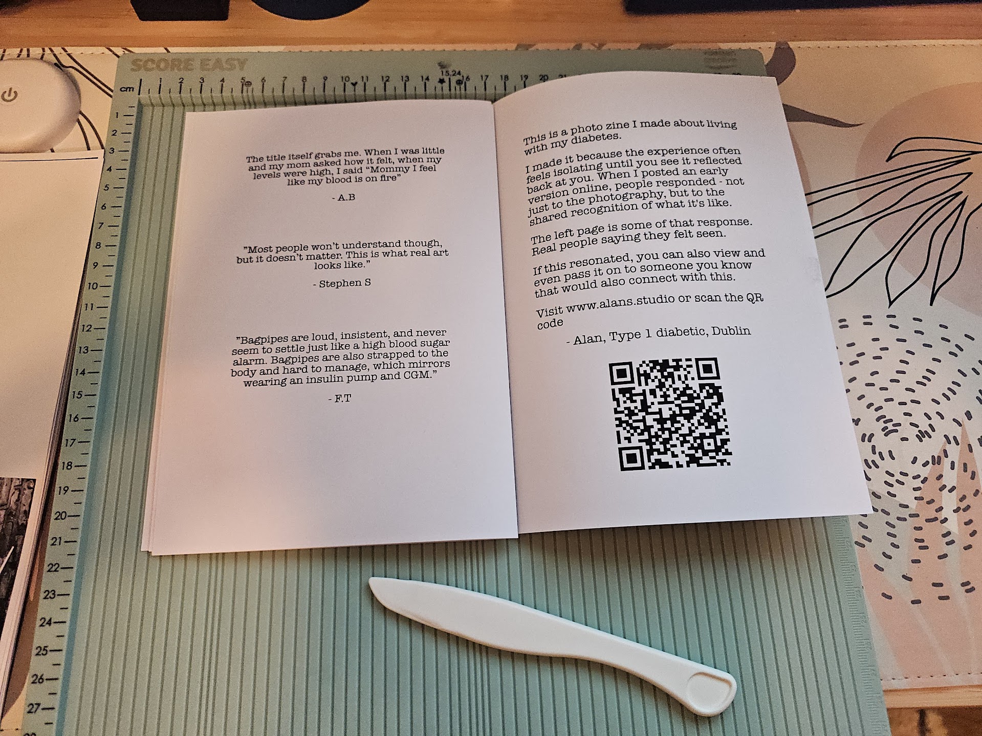 Finished zine on a cutting mat with bone folder
